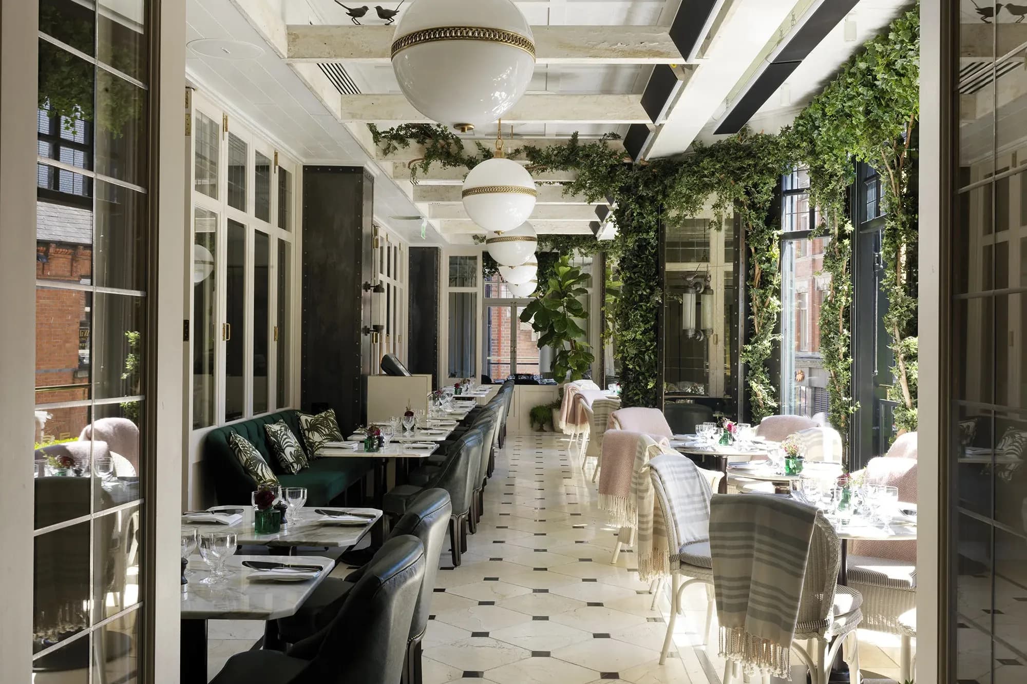 a dining room filled with greenery