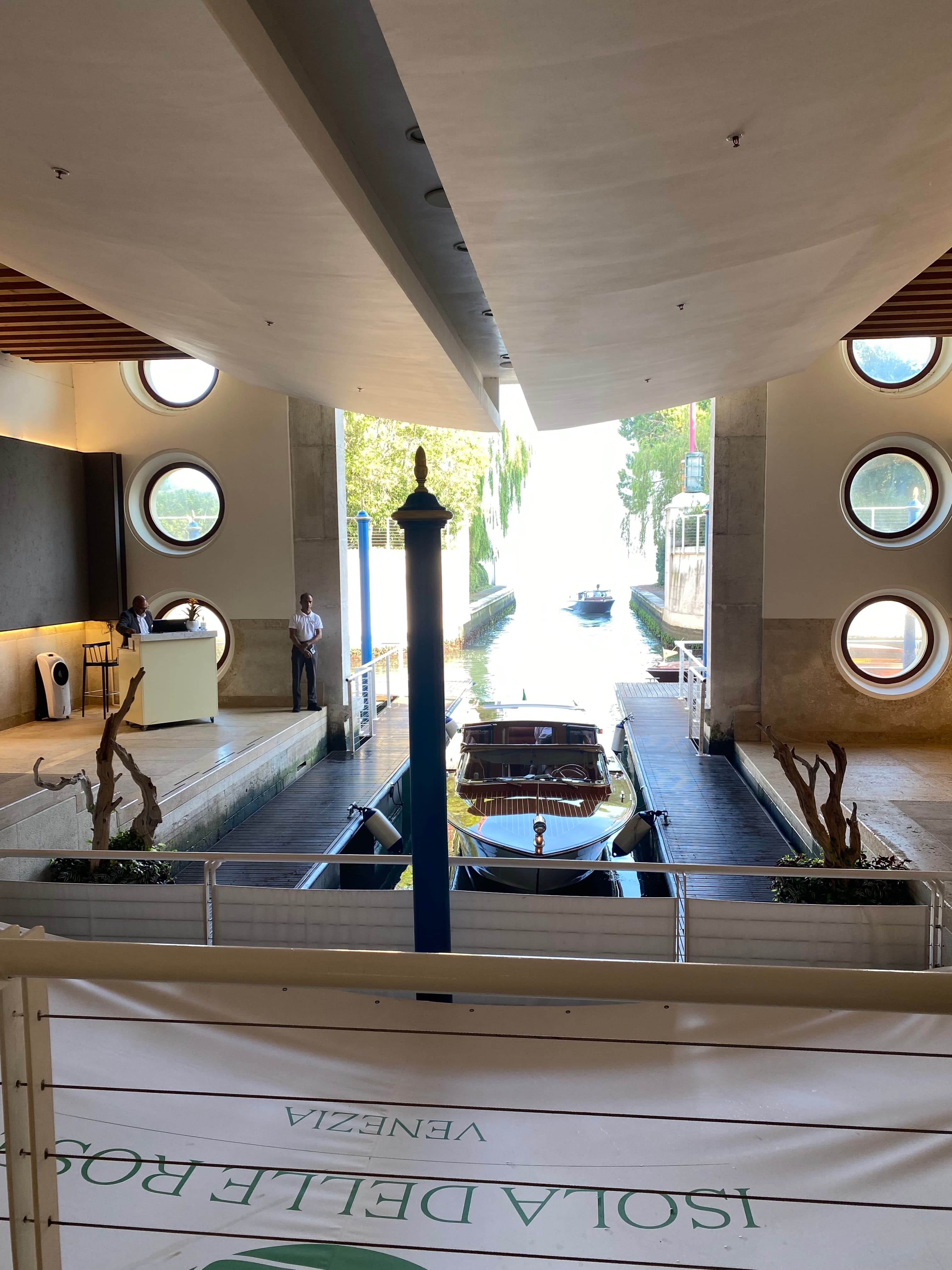 Entrance of JW Marriott Venice Resort & Spa – a covered outdoor entryway with a boat parked in front of the check-in desk