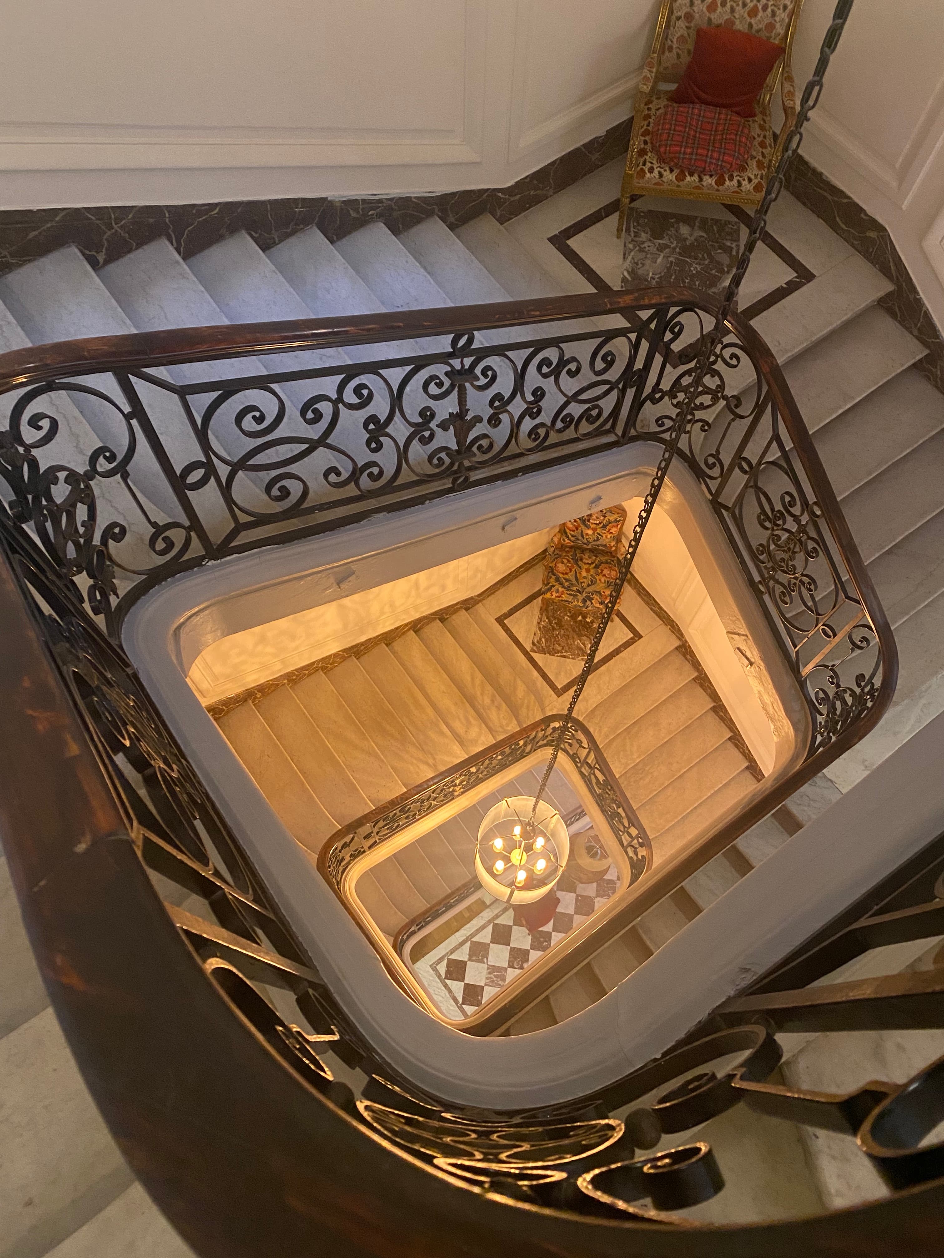 Ritz Paris hotel – view from the top of a marble staircase with a chandelier in the center