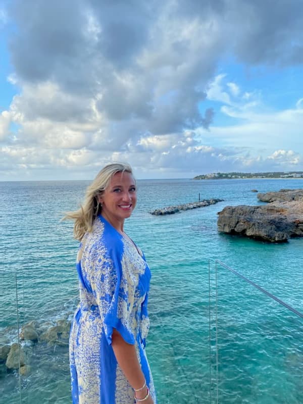 Picture of Mckenzie in blue and white dress with beautiful sea view