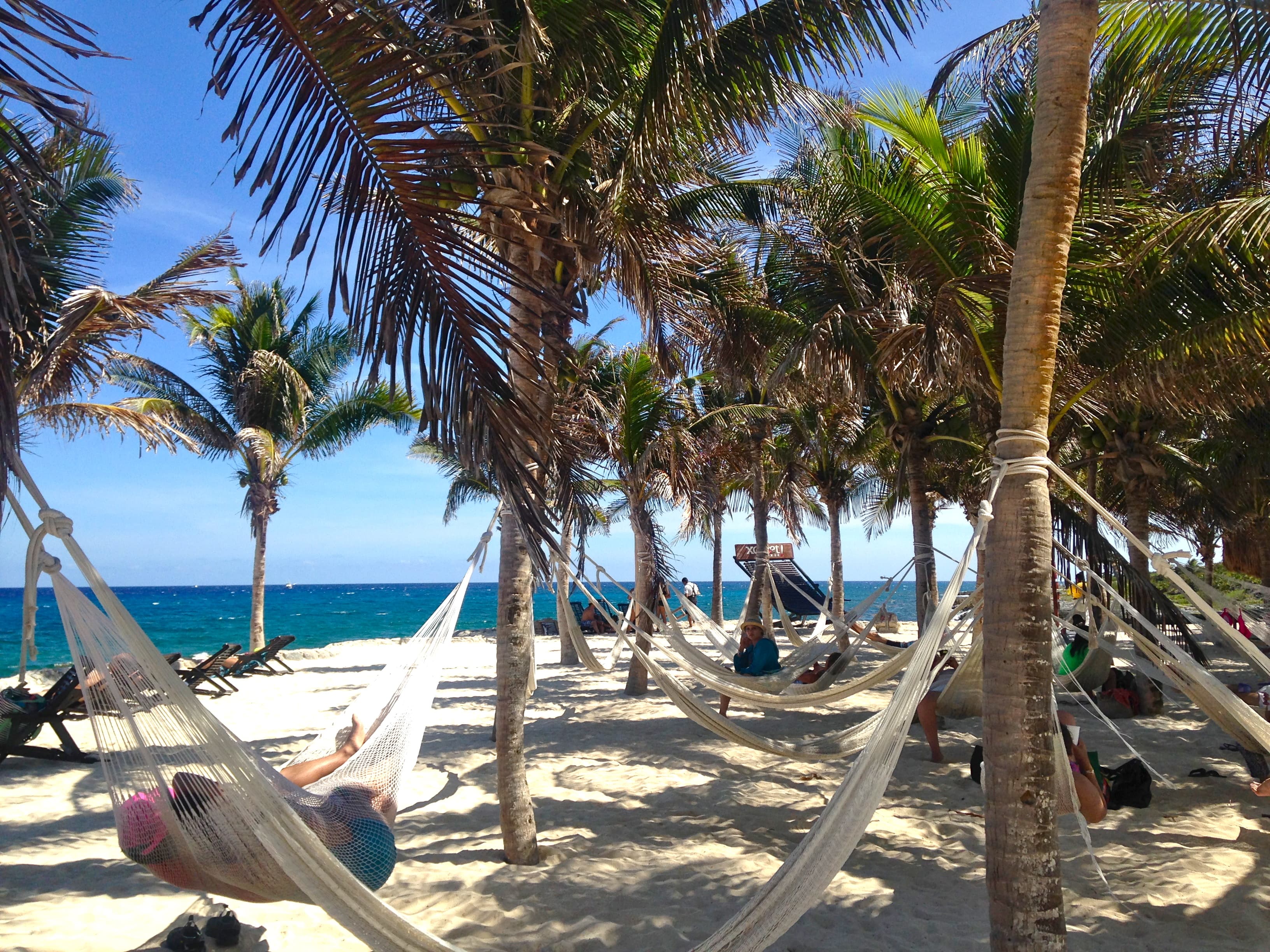People relaxing on hammocks on the beach