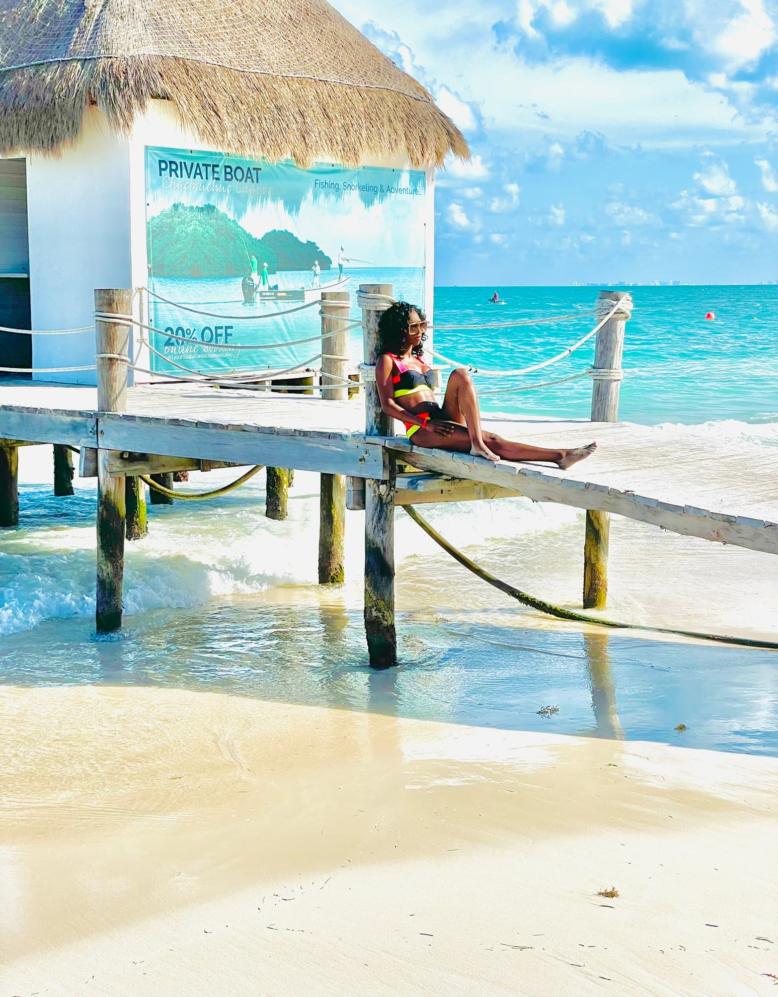Posing for a picture by a beach hut