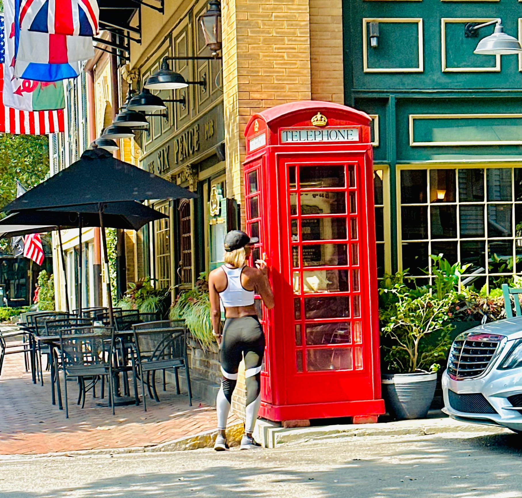 Standing by a telephone booth
