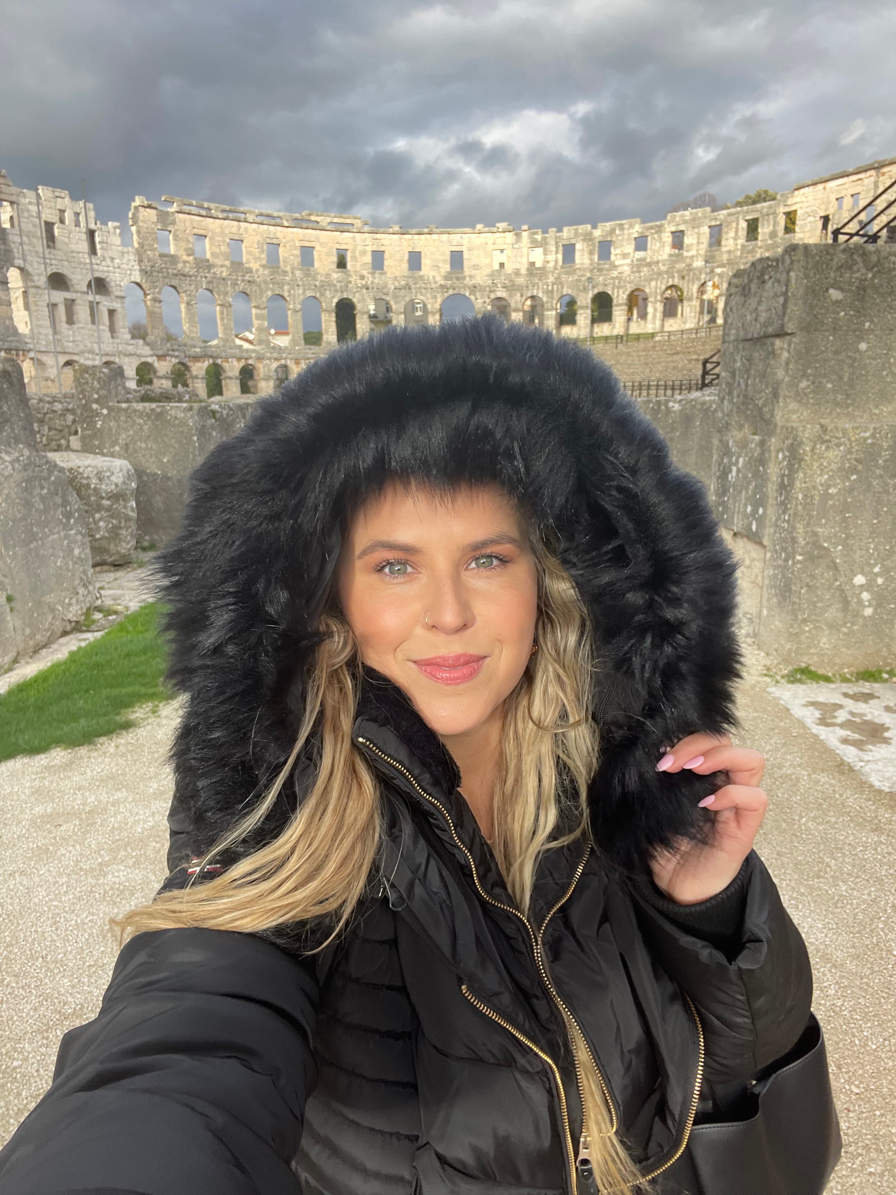 Posing for a picture in the Colosseum