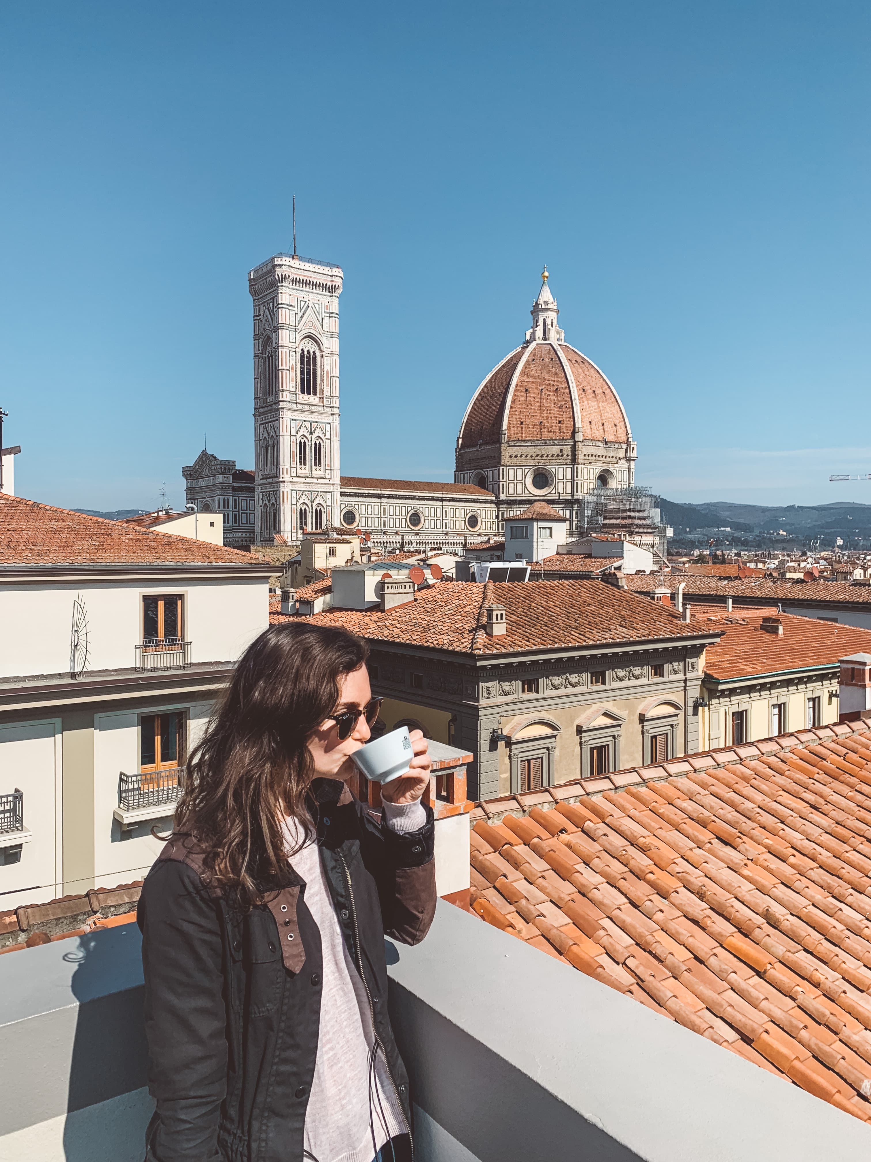 Picture of Sarah drinking tea with Cathedral of Santa Maria del Fiore in view