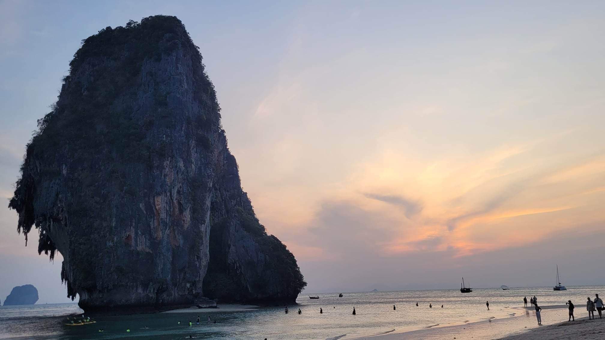 View of people on the beach at sunset