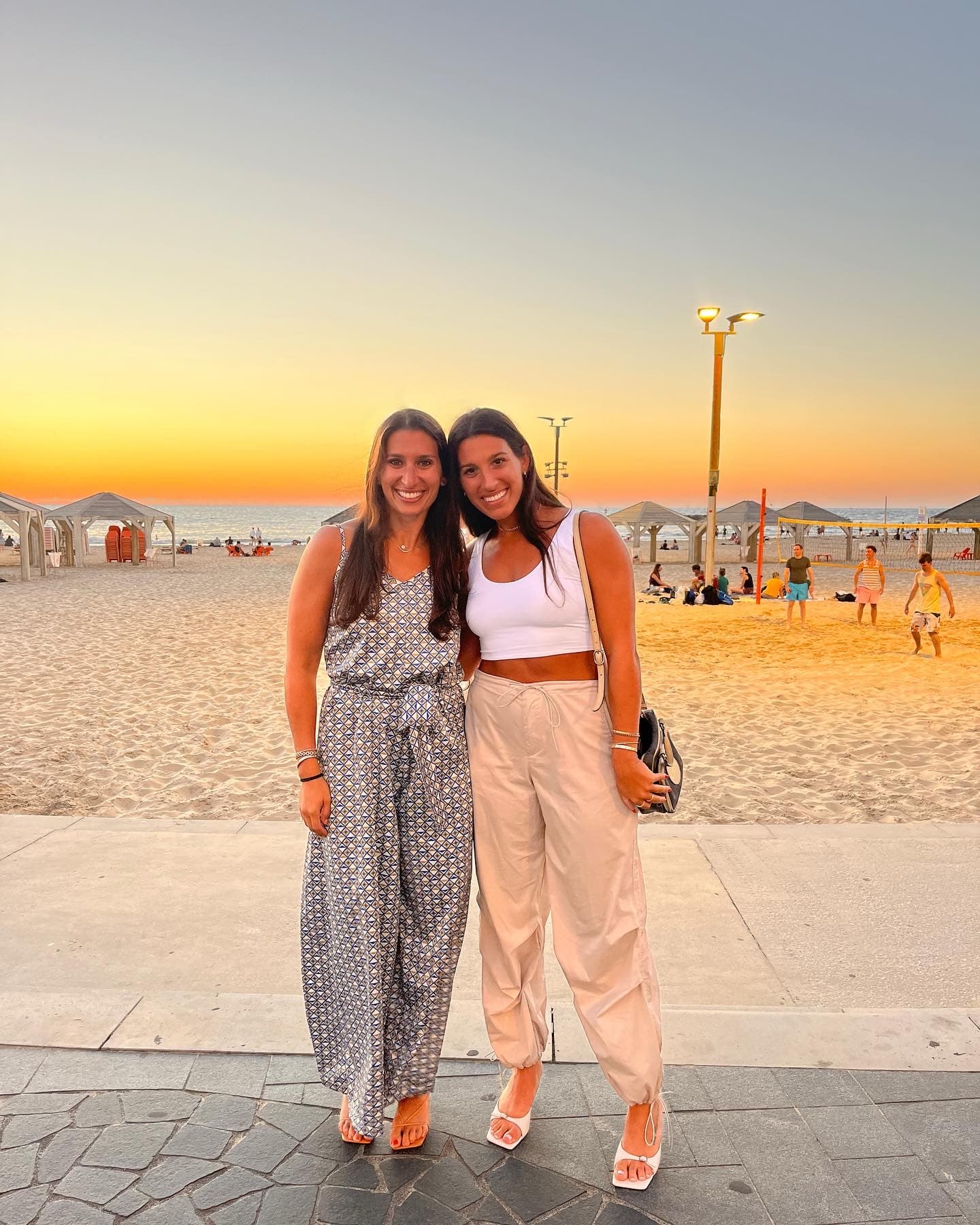 Posing for a picture with a friend on the beach