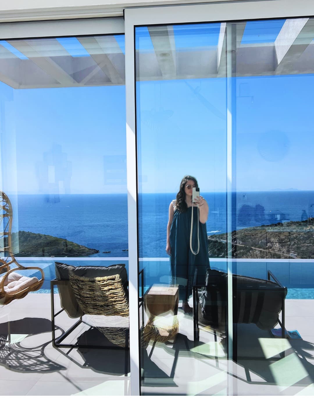 Picture of Nora in black dress at hotel with beautiful sea view