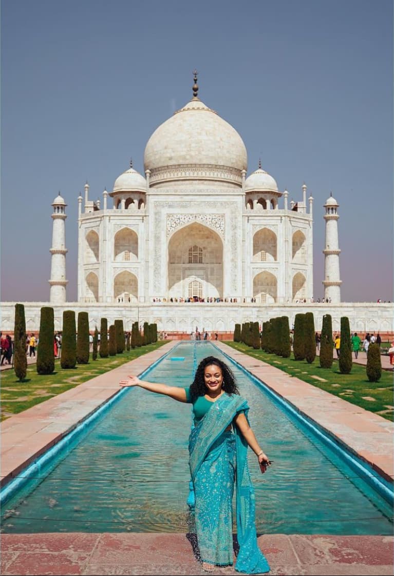 Posing for a picture in front of Taj Mahal