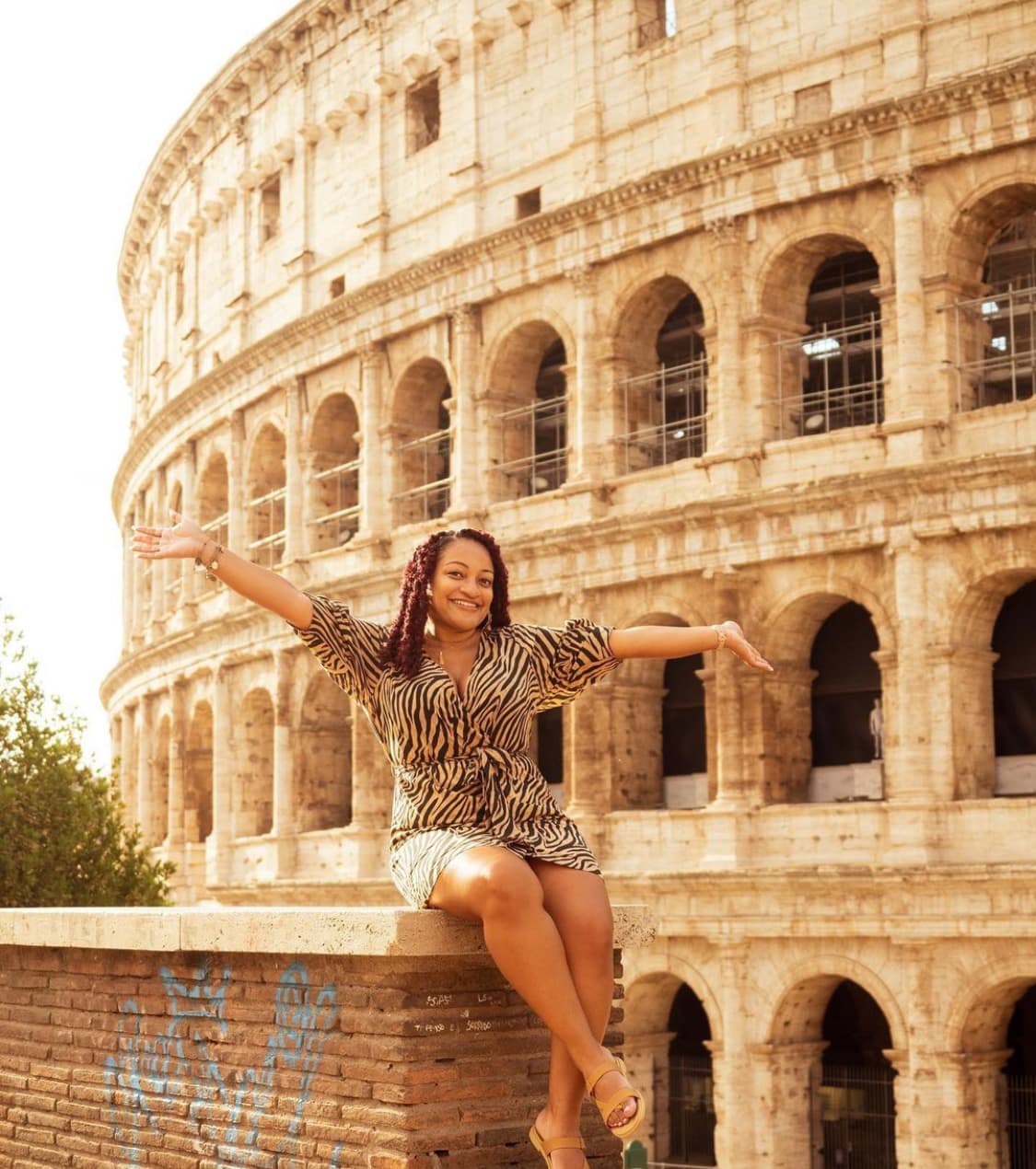 Posing for a picture in front of the Colosseum