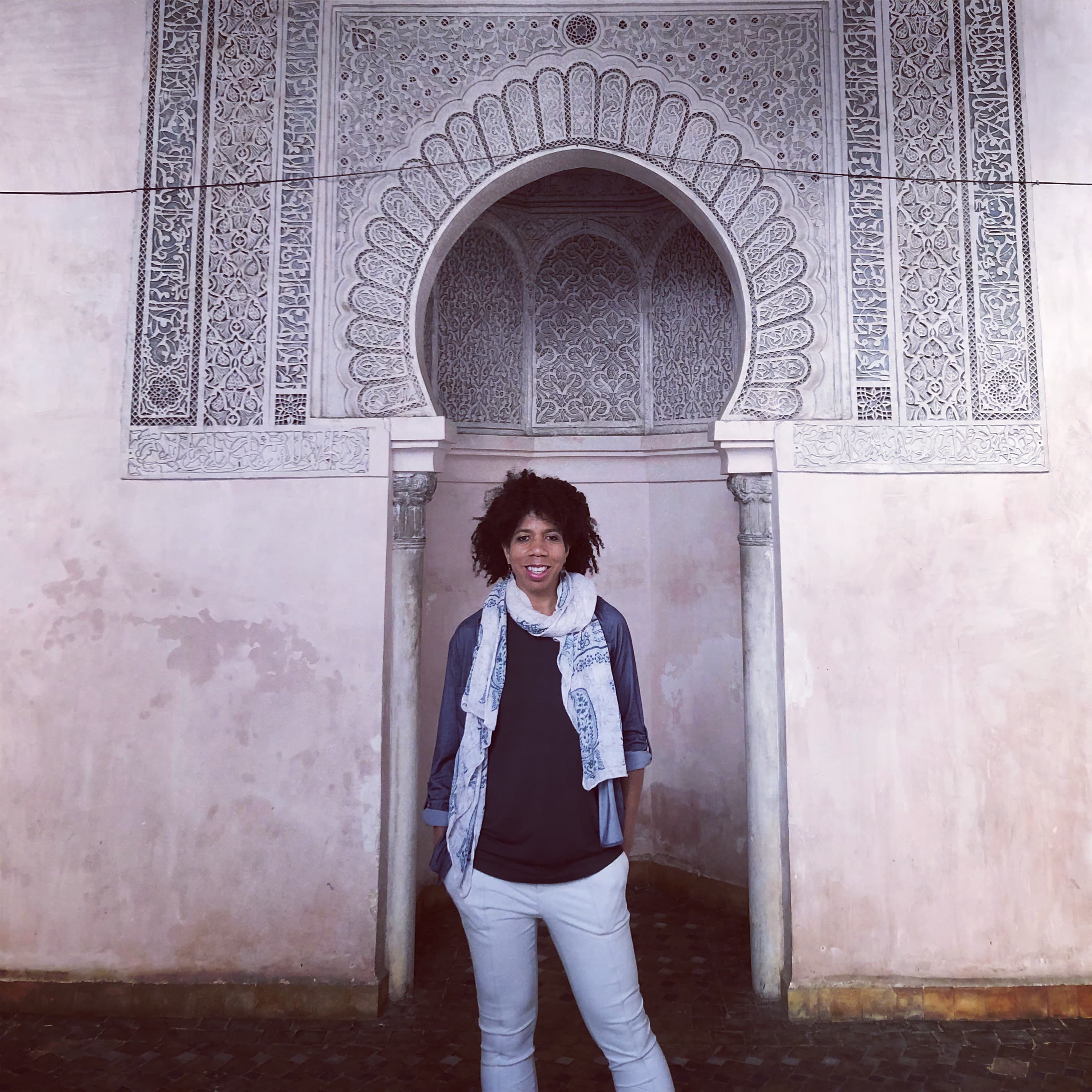 Posing for a picture with carving on the wall