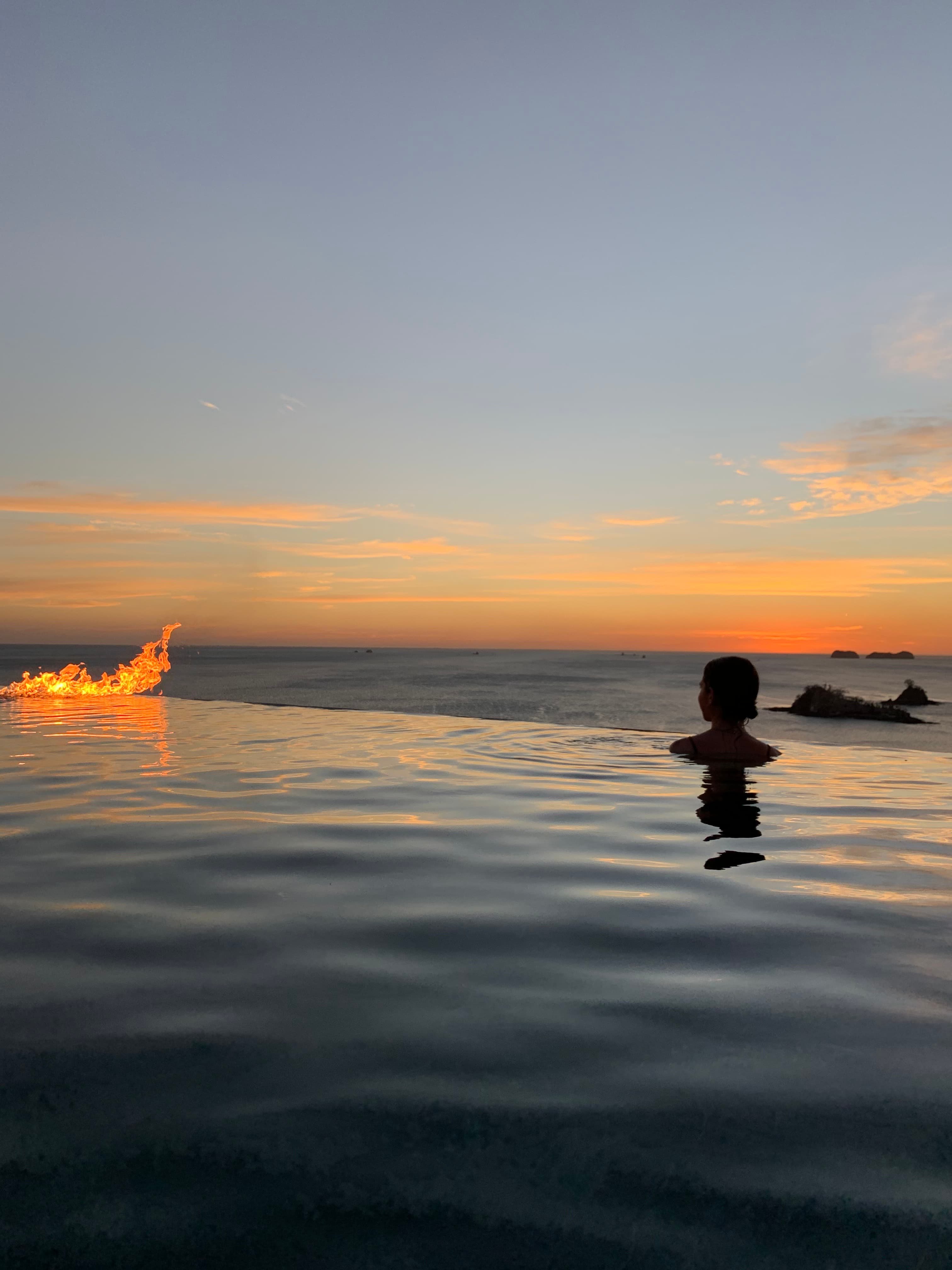 Swimming in the pool at sunset