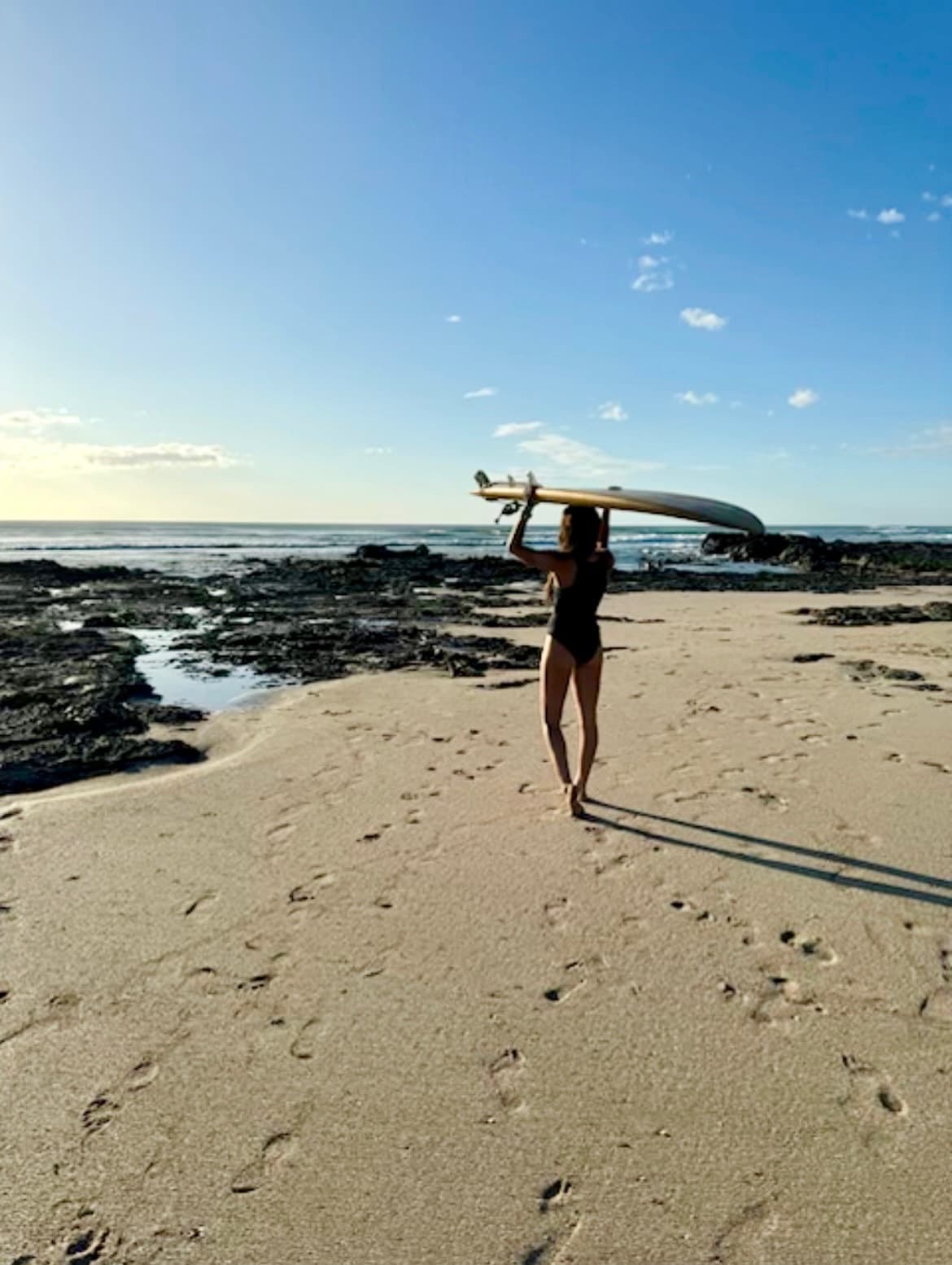 Carrying a surfboard on the beach