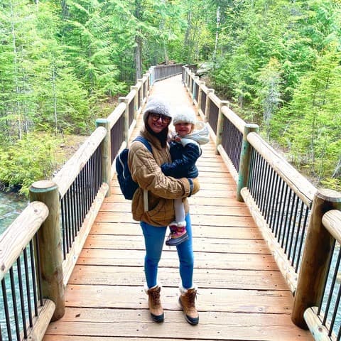 Posing for a picture with baby on a bridge