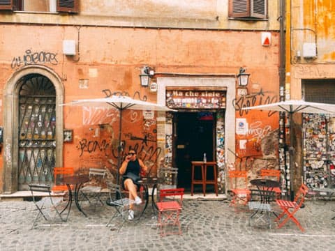 Sitting on chairs outside a small shop