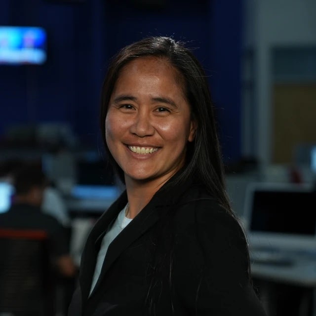 Beth Nakamura smiling in an office.