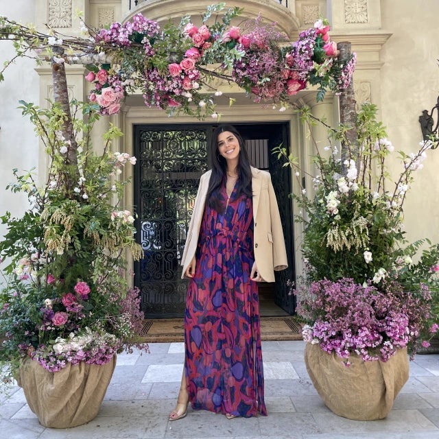 Fora travel advisor Liza Goncharov wearing purple dress standing next to flower pots during daytime
