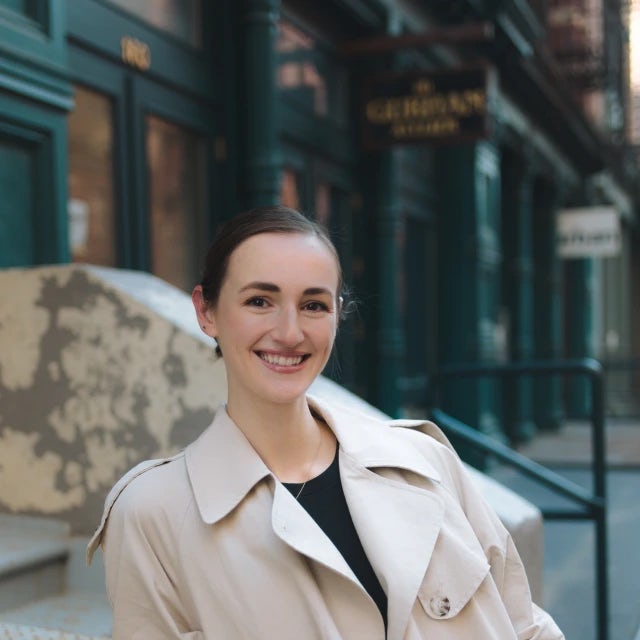 Travel Advisor Julia Asselin on a city street in a khaki coat.