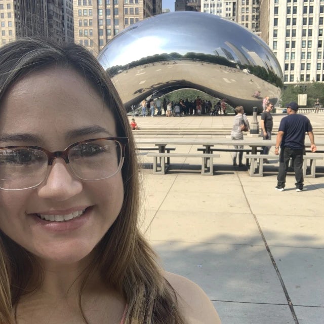 Fora travel agent Aimee Barbier standing in front of the Chicago Bean