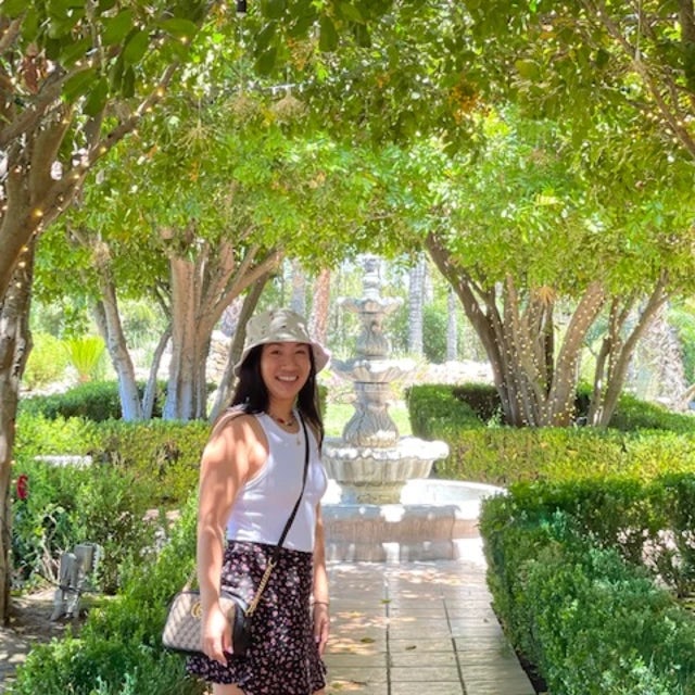 Fora travel agent Kathy Nguyen standing in a park
