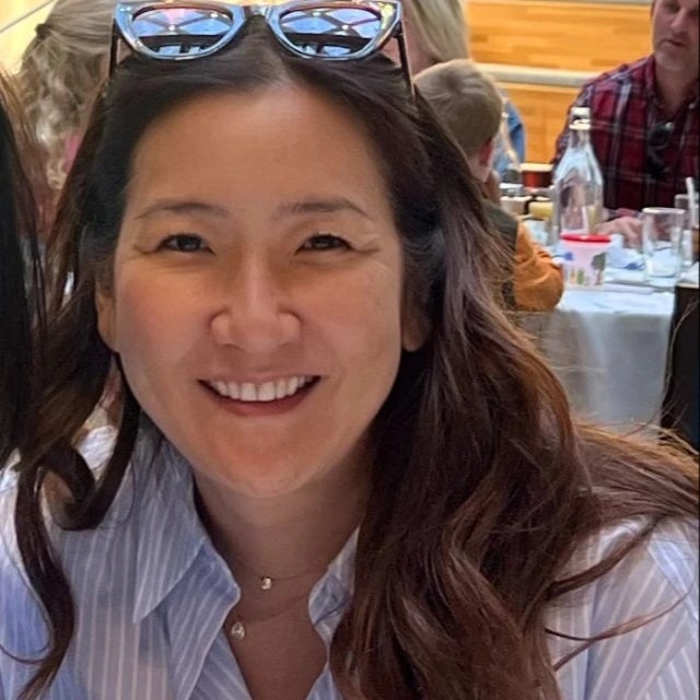 travel advisor Janet Park smiling in a striped shirt