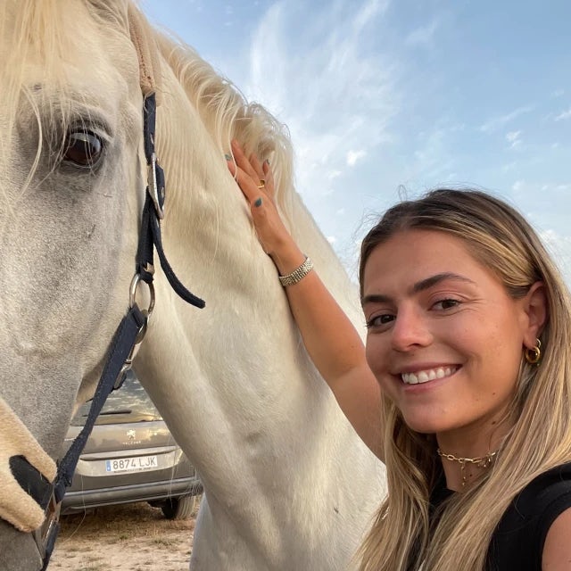 Travel Advisor Danielle DeBiasi in a black shirt with a white horse.