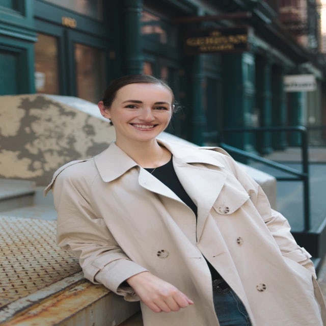 Travel Advisor Julia Asselin on a city street in a khaki coat.