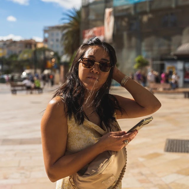 Travel Advisor Leanna Truong in a yellow top outside in a square.