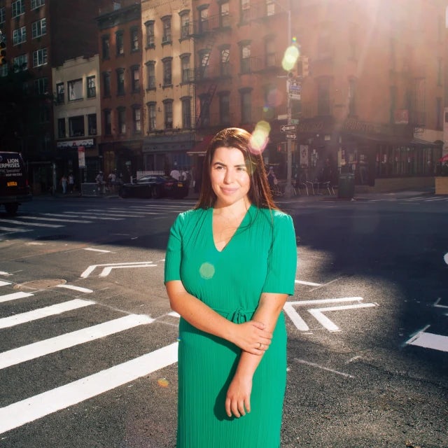 Travel Advisor Megan Ashley poses backlit on a New York City street.