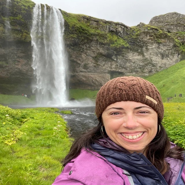 Travel advisor Sarah Turner taking selfie in front of a water fall.