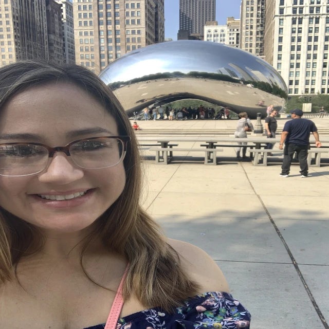 Fora travel agent Aimee Barbier standing in front of the Chicago Bean