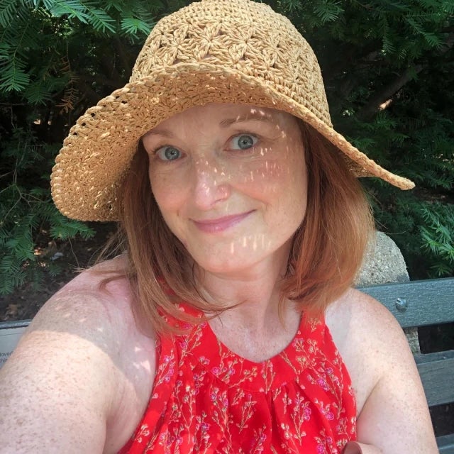 Travel advisor Jenny Kager in a sunhat and red top