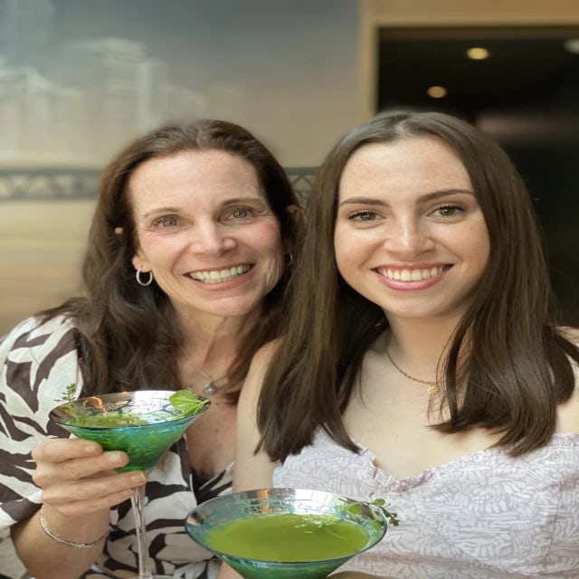 Travel advisor Julie Middlebrook-Levin with her daughter holding green and blue martini glasses