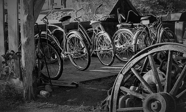 A black and white photo of a group of bicycles