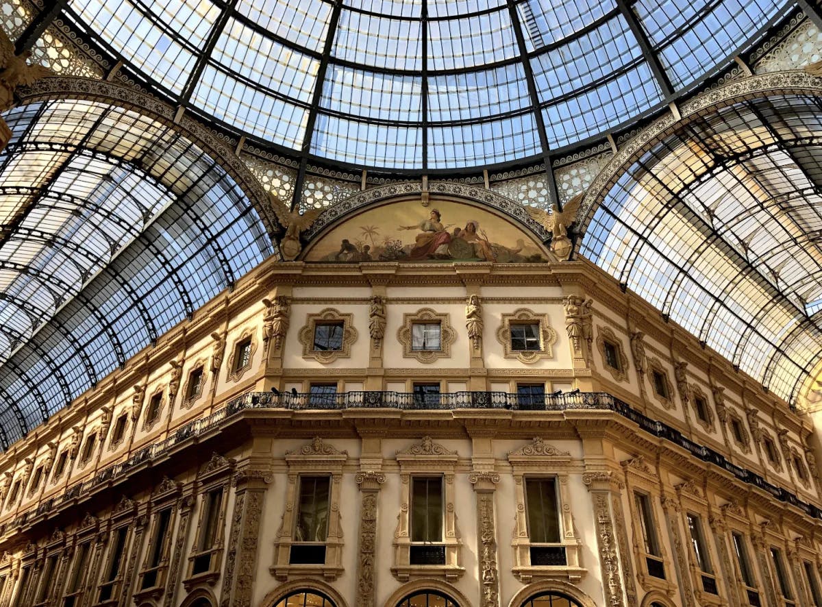 A shopping center in Milan with elaborate architectural detailing and a curved glass ceiling. 