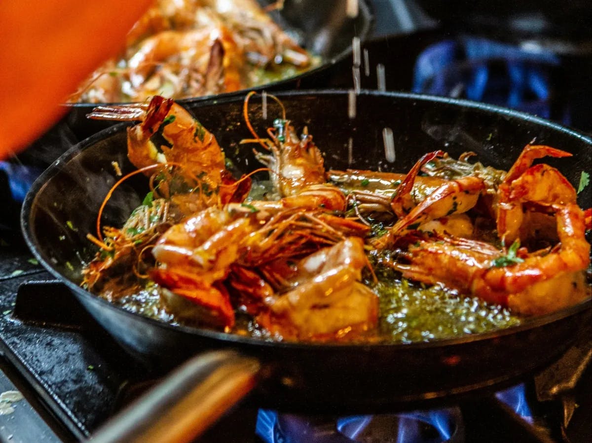 Crawfish being cooked in a pan.