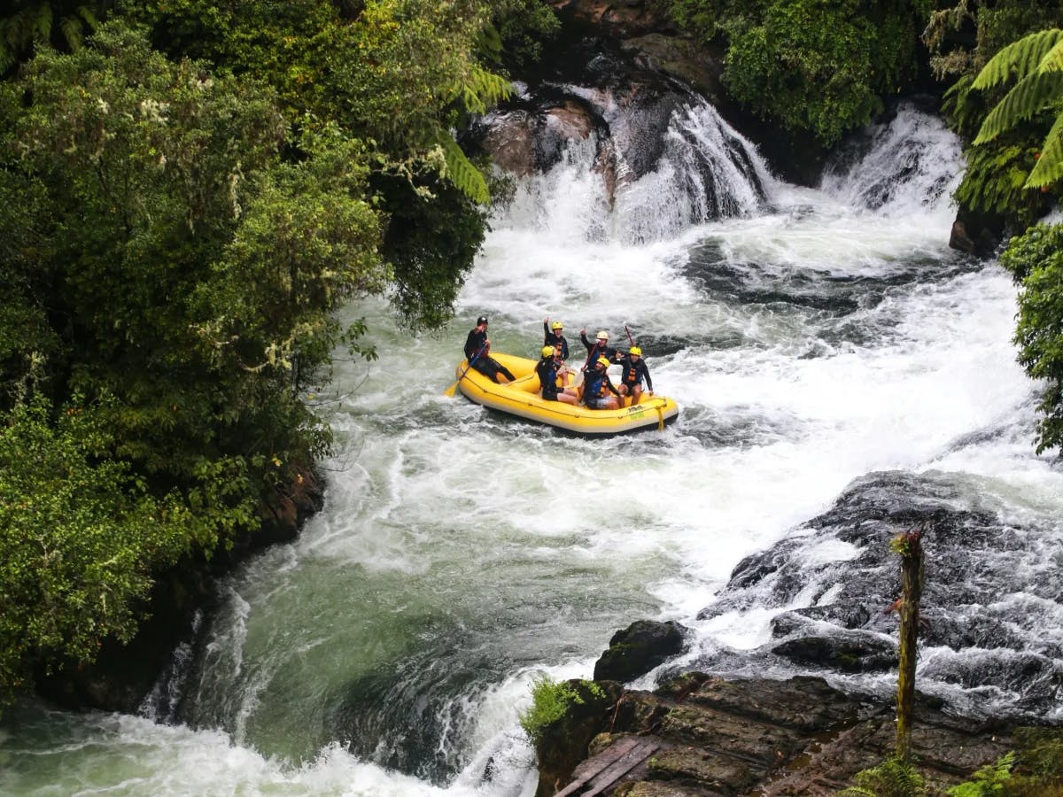 An aerial view of people on yellow boat, river rafting during daytime.
