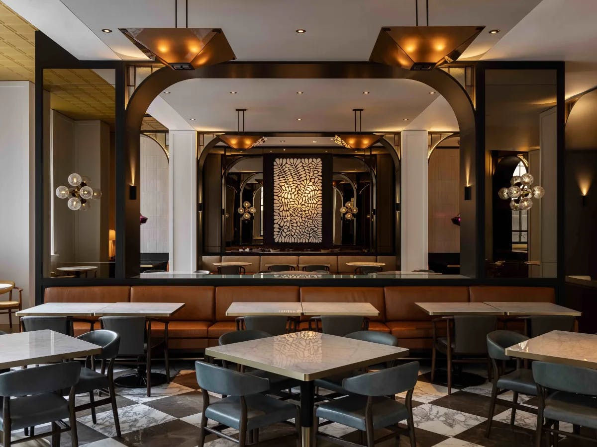 The image showcases a chic and contemporary interior, likely of a restaurant or bar, exuding sophistication with its stylish decor and lighting.