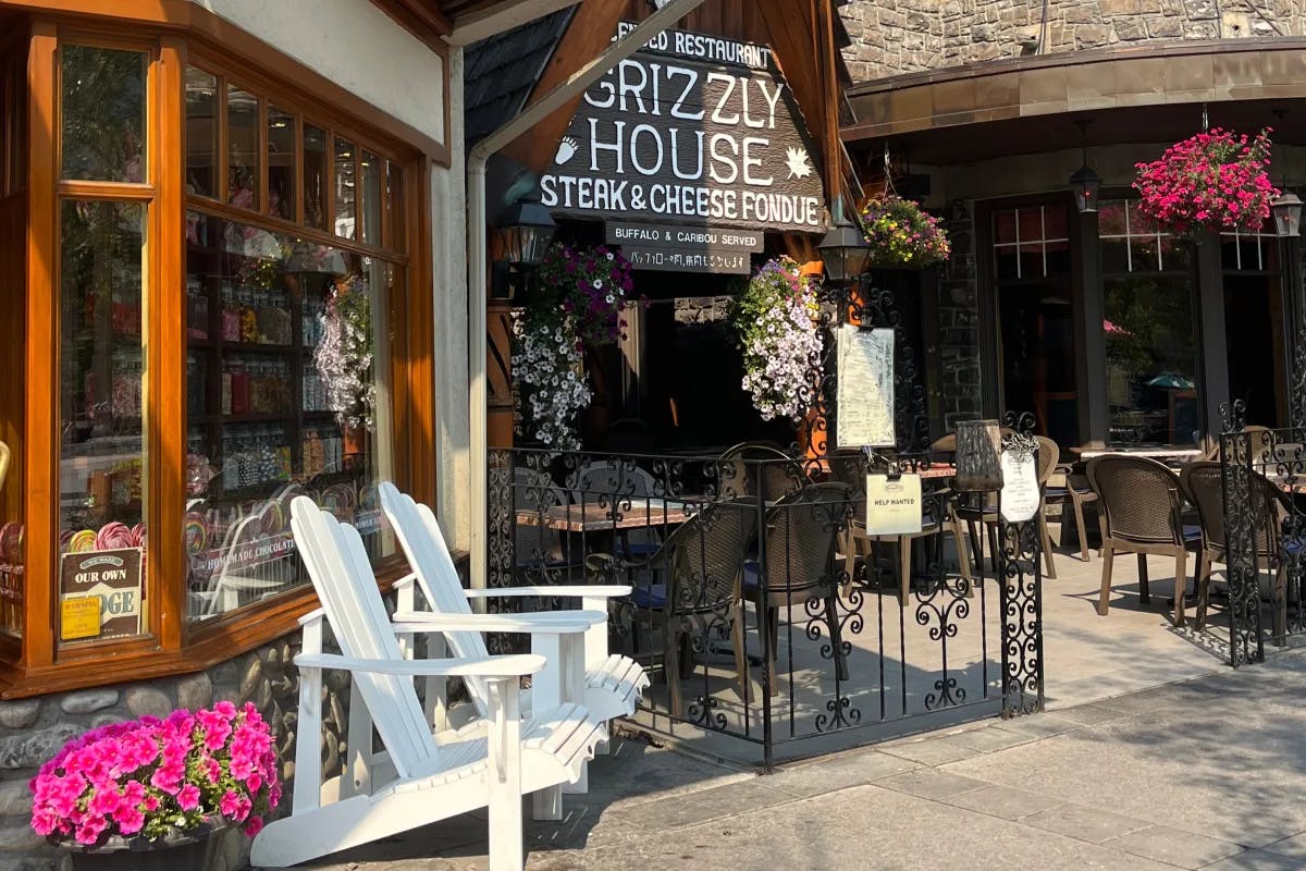 The facade of the Grizzly House restaurant  known for its fondue feast with white deckchairs outside