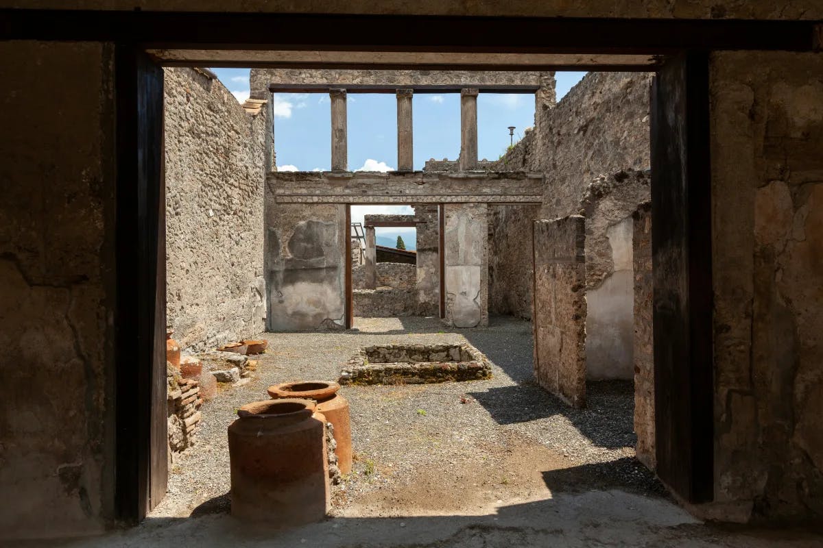 A picture taken from a door frame of the ruins of buildings.