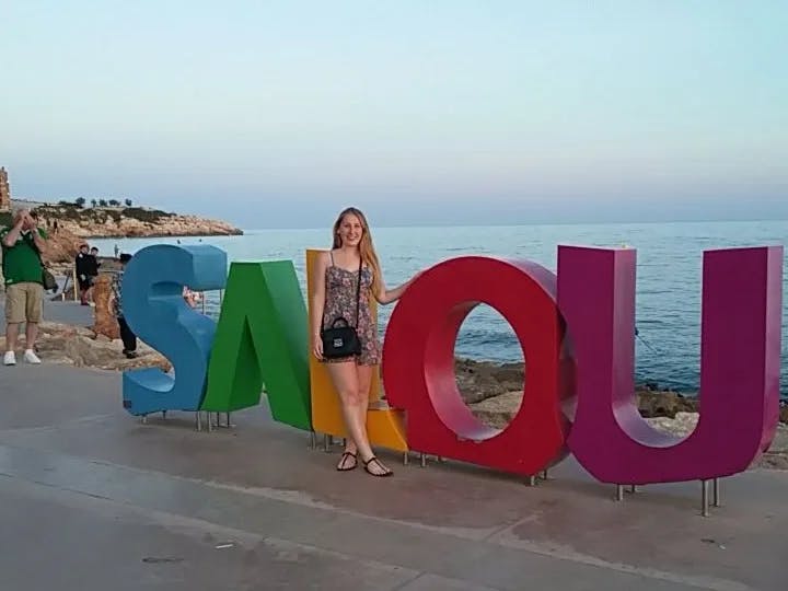 Travel Advisor posing next to Salou Spain sign