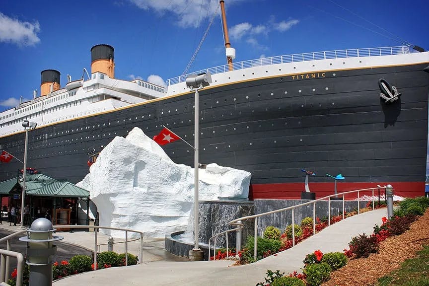 The outside of the Titanic Museum, with a replica iceberg in front of a large ship.
