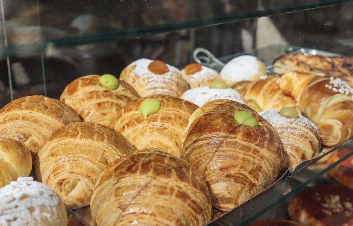 A display case full of croissants with various fillings. 