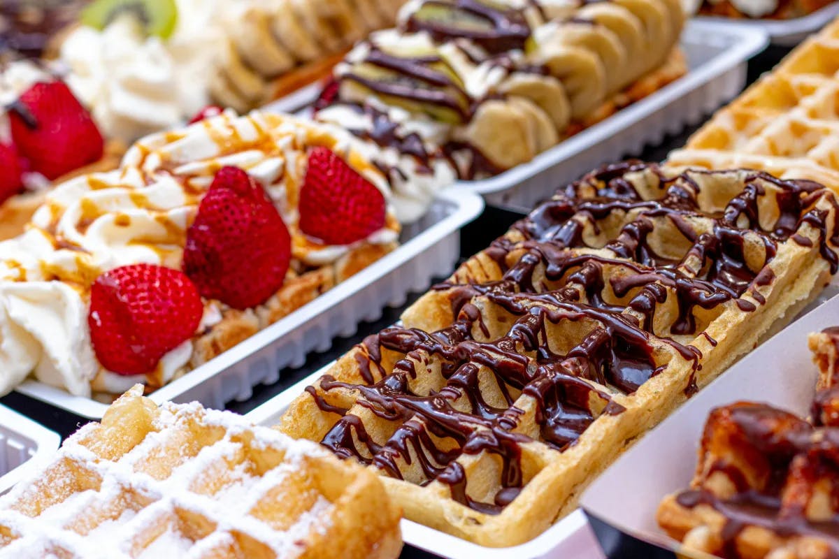 A picture of rows of Waffles with different toppings.