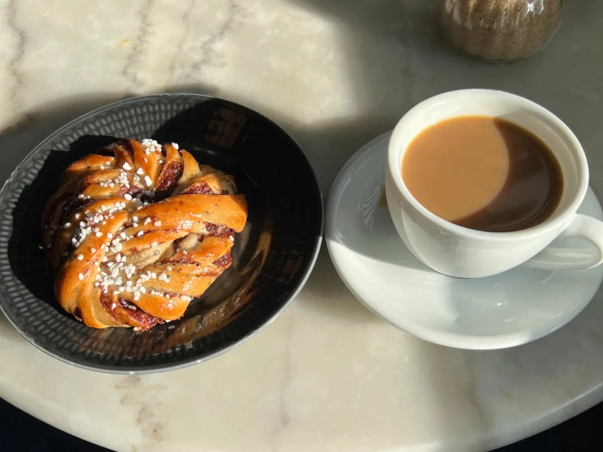 Coffee with a pastry on a marble table
