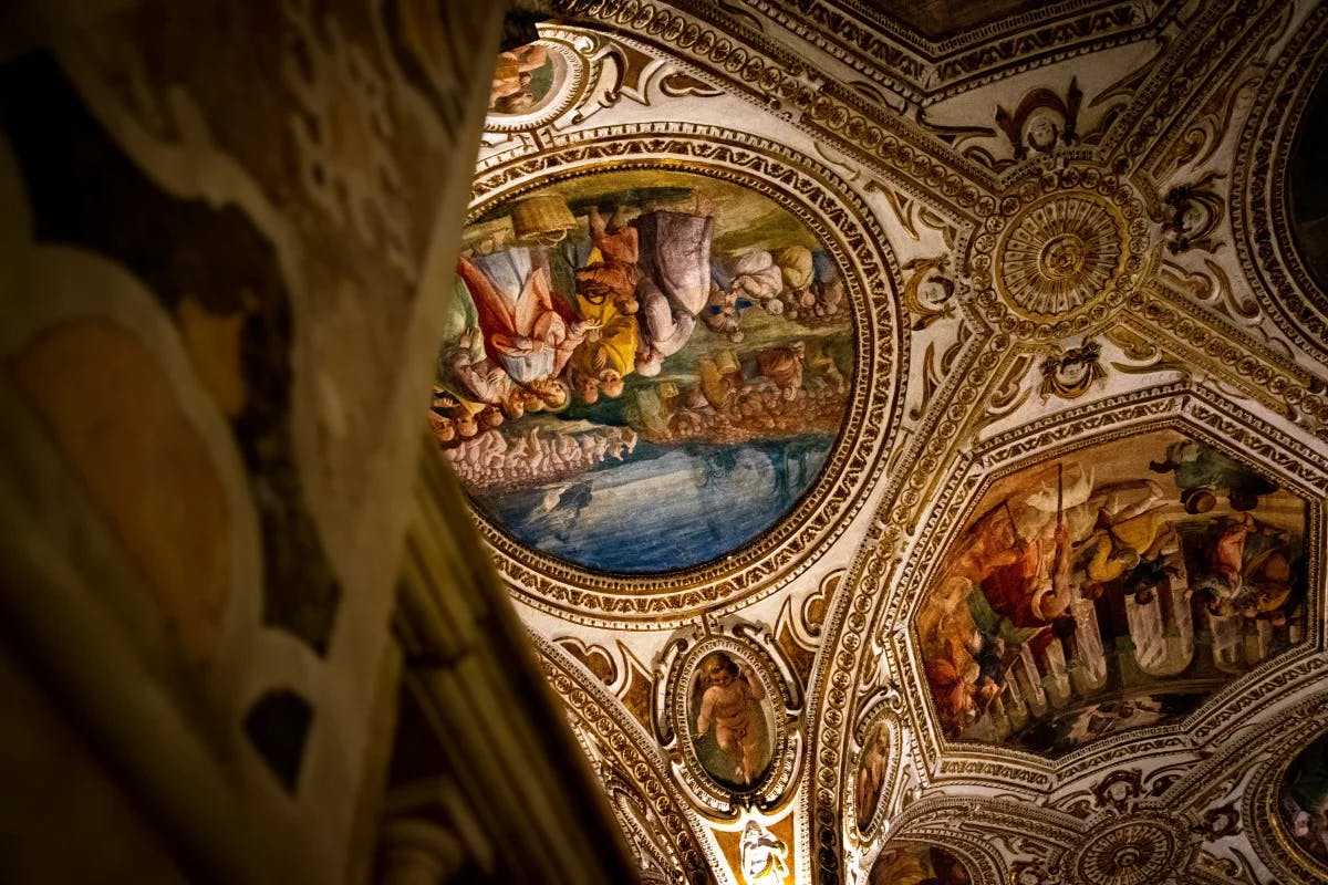 A picture of the ceiling of a building with paintings on it at Salerno Cathedral.