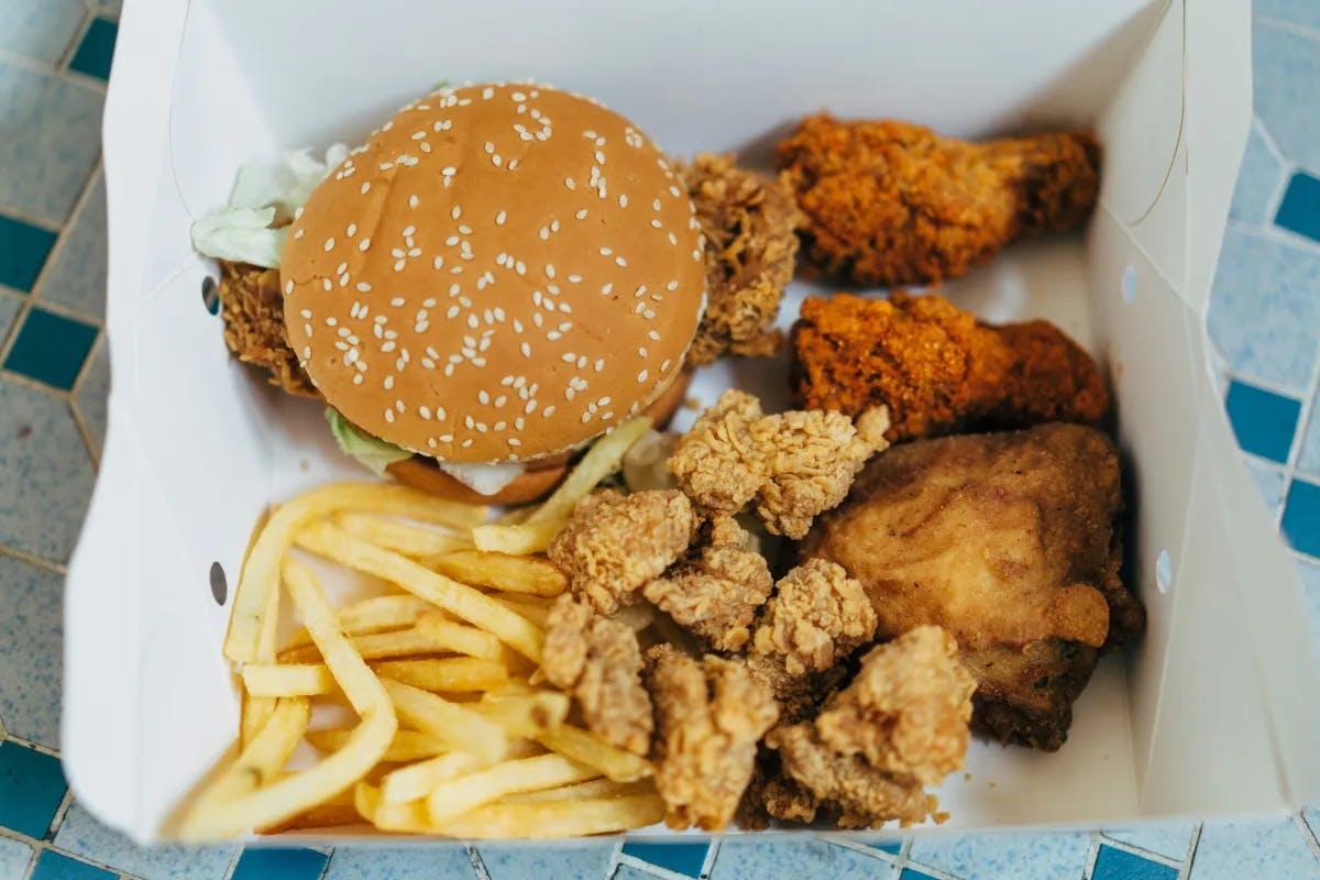 A close picture of a box of food served on a table. 