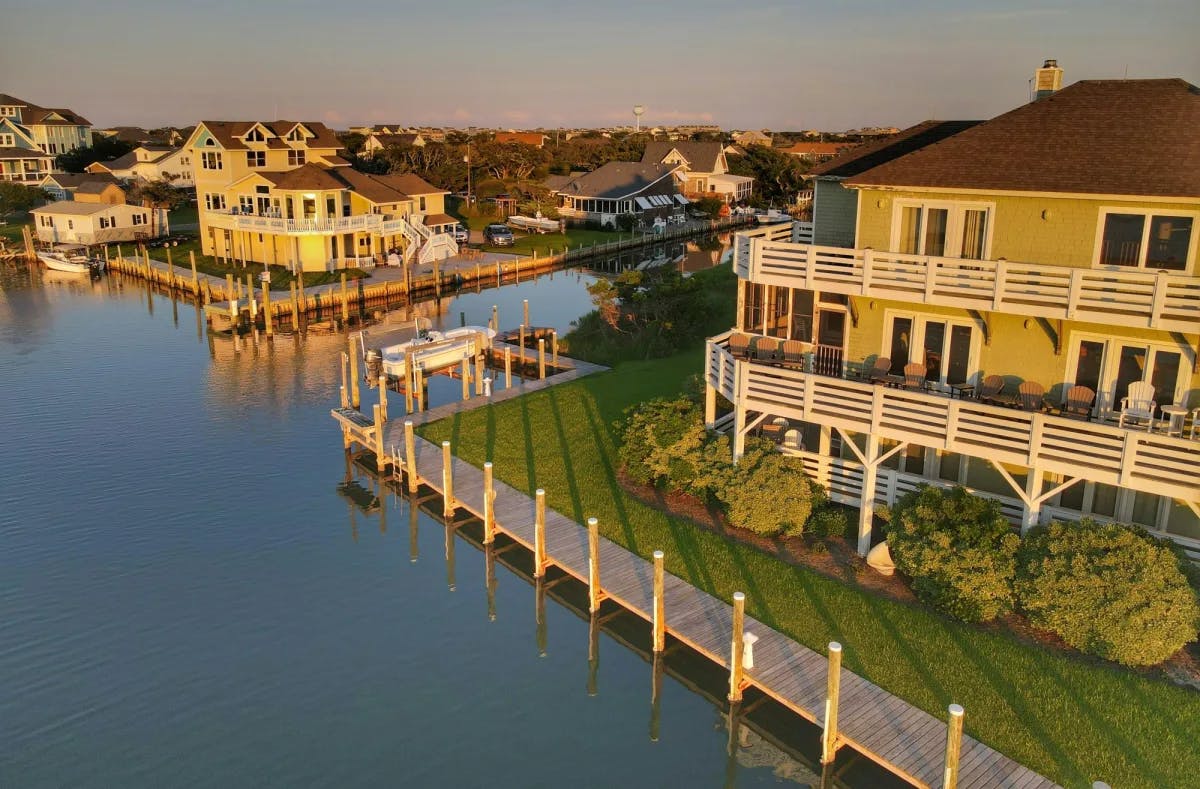Beautiful homes, manicured lawns and bushes and boardwalks surrounding water. 