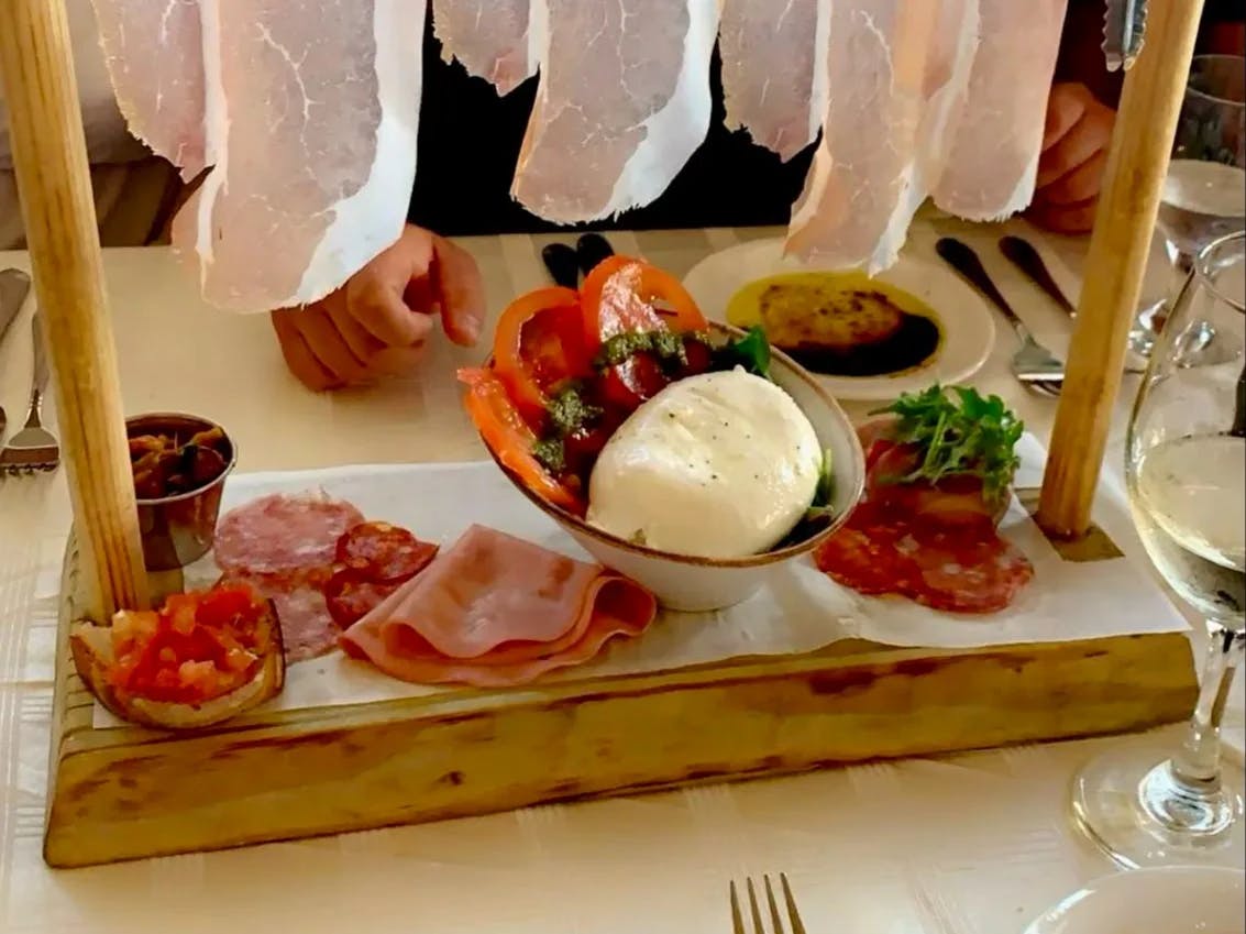 a delicious spread of meat and cheeses with dips on tower presentation. 