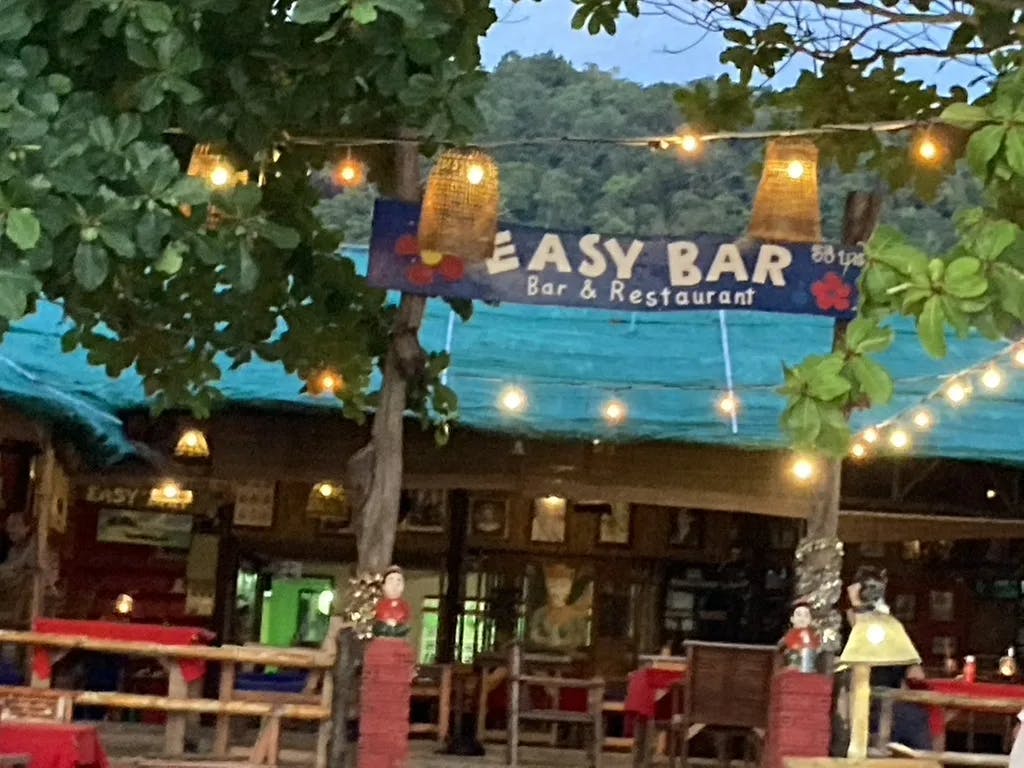 A picture of Easy Bar with outside lights in the evening. 